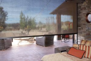 An inside view of Oasis® 2900 Patio Insect Shades showing a clear view of a sitting area outside